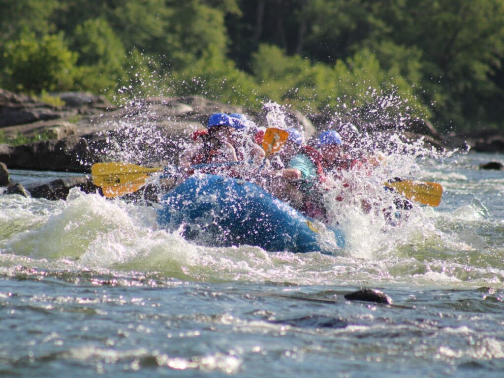 group of rafters paddling down white water section of the Shenandoah river
