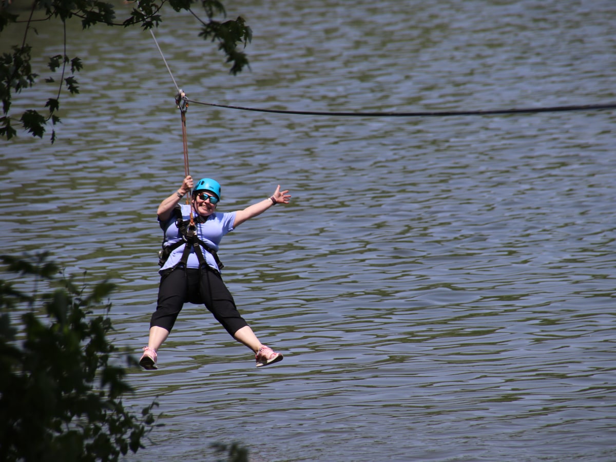 woman on zipline with arms and legs spread