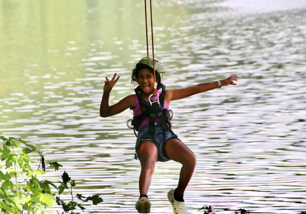 girl ziplining at River Riders during the spring