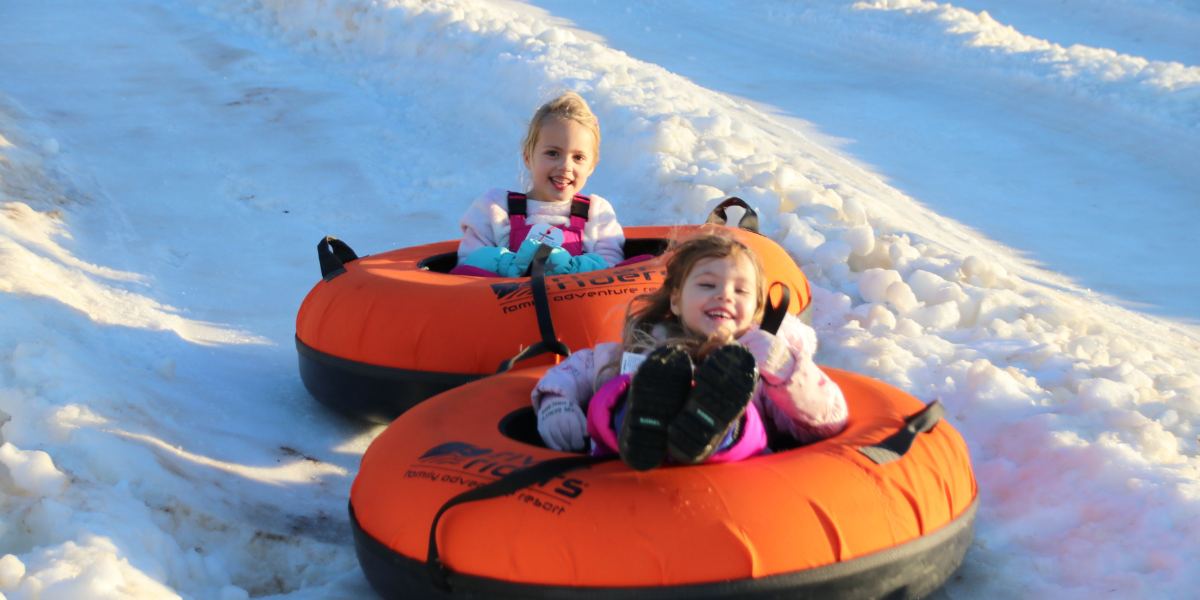 two little girls snow tubing in west virginia