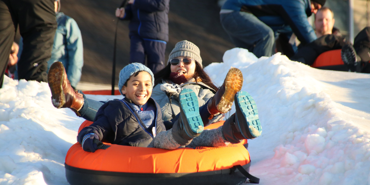 mom and son snow tubing in west virginia near washington dc