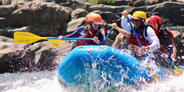 rafters getting splashed in a rapid