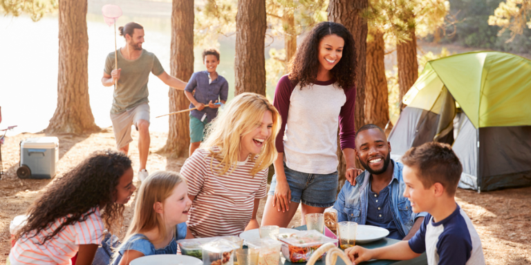 group laughing at camp table